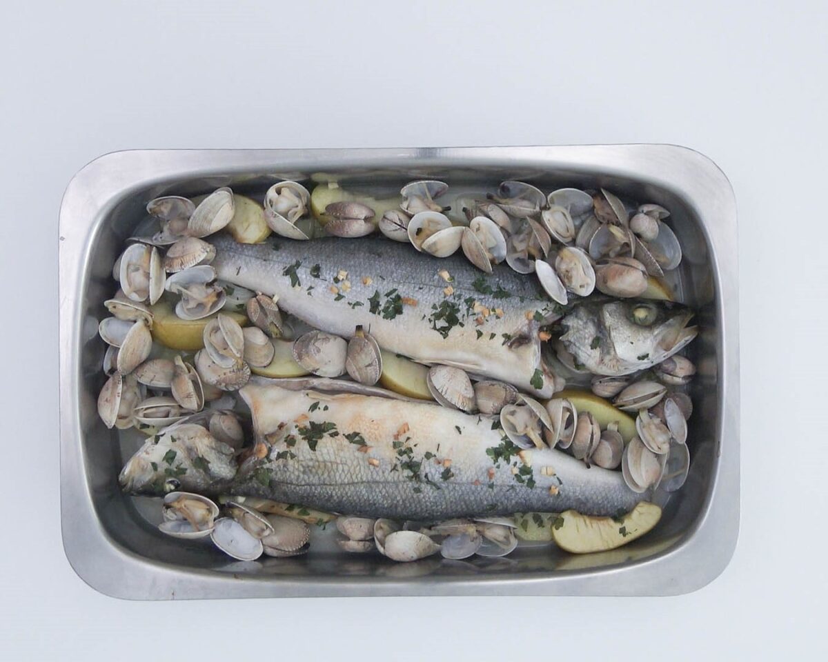 Lubina al horno con patatas, manzana y almejas