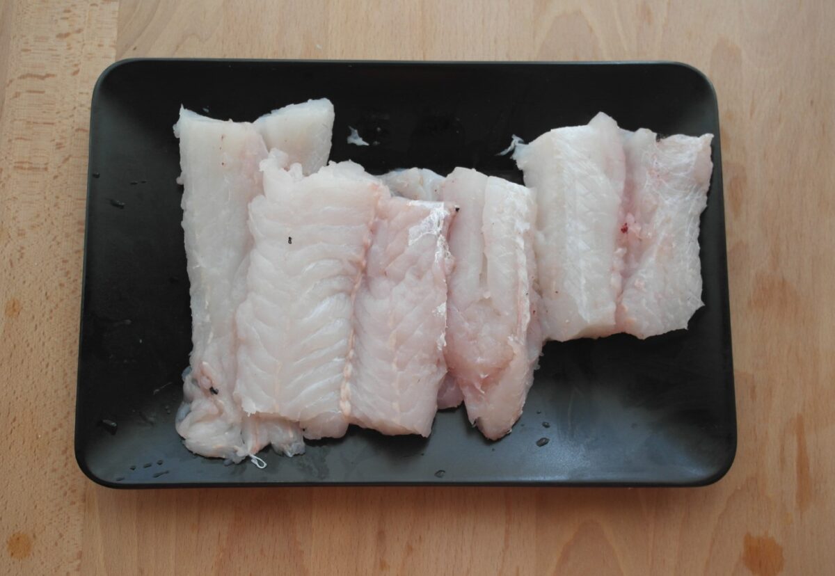 Merluza al horno con langostinos en salsa de tomate. Receta de pescado paso a paso