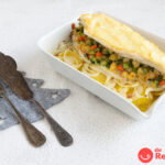 Lubina rellena de gambas y gratinada con patatas