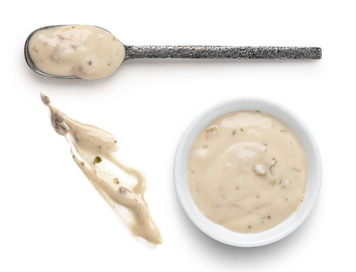 Bowl,And,Spoon,With,Mushrooms,Sauce,Isolated,On,White,Background